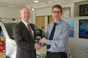 Dean Matthews receiving his Vauxhall award from Matthew Piper