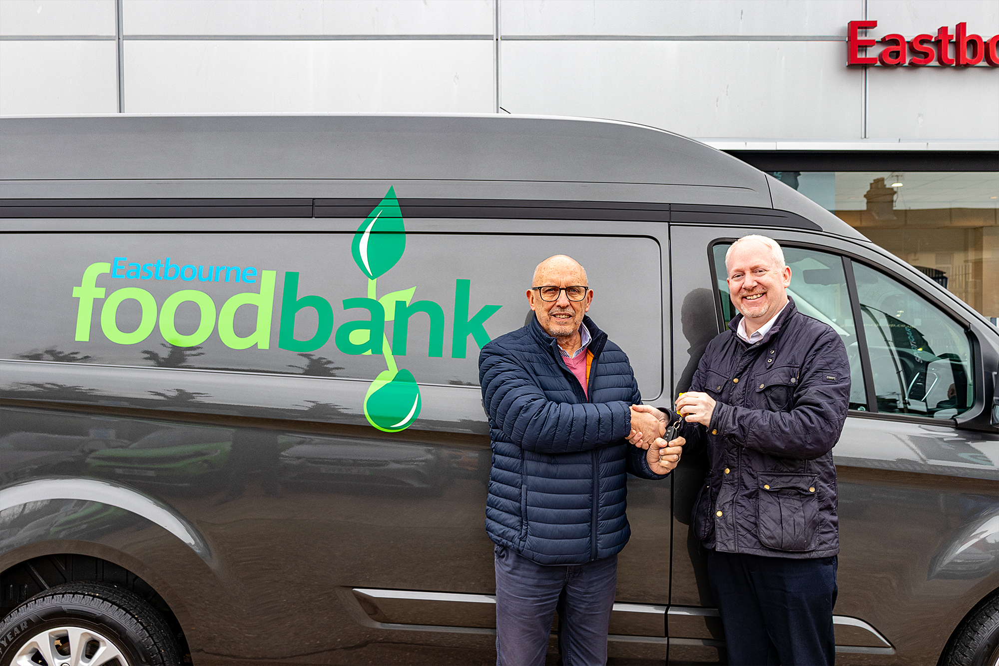 Howard Wardle, CEO of Eastbourne Foodbank collecting the new van from Dean Matthews