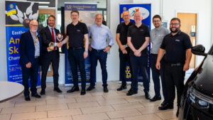 Eastbourne Motoring Centre skittles team receiving the Eastbourne Skittles Championship shield and highest individual score trophy at Eastbourne Motoring Centre on 23 July after their fourth consecutive championship victory.