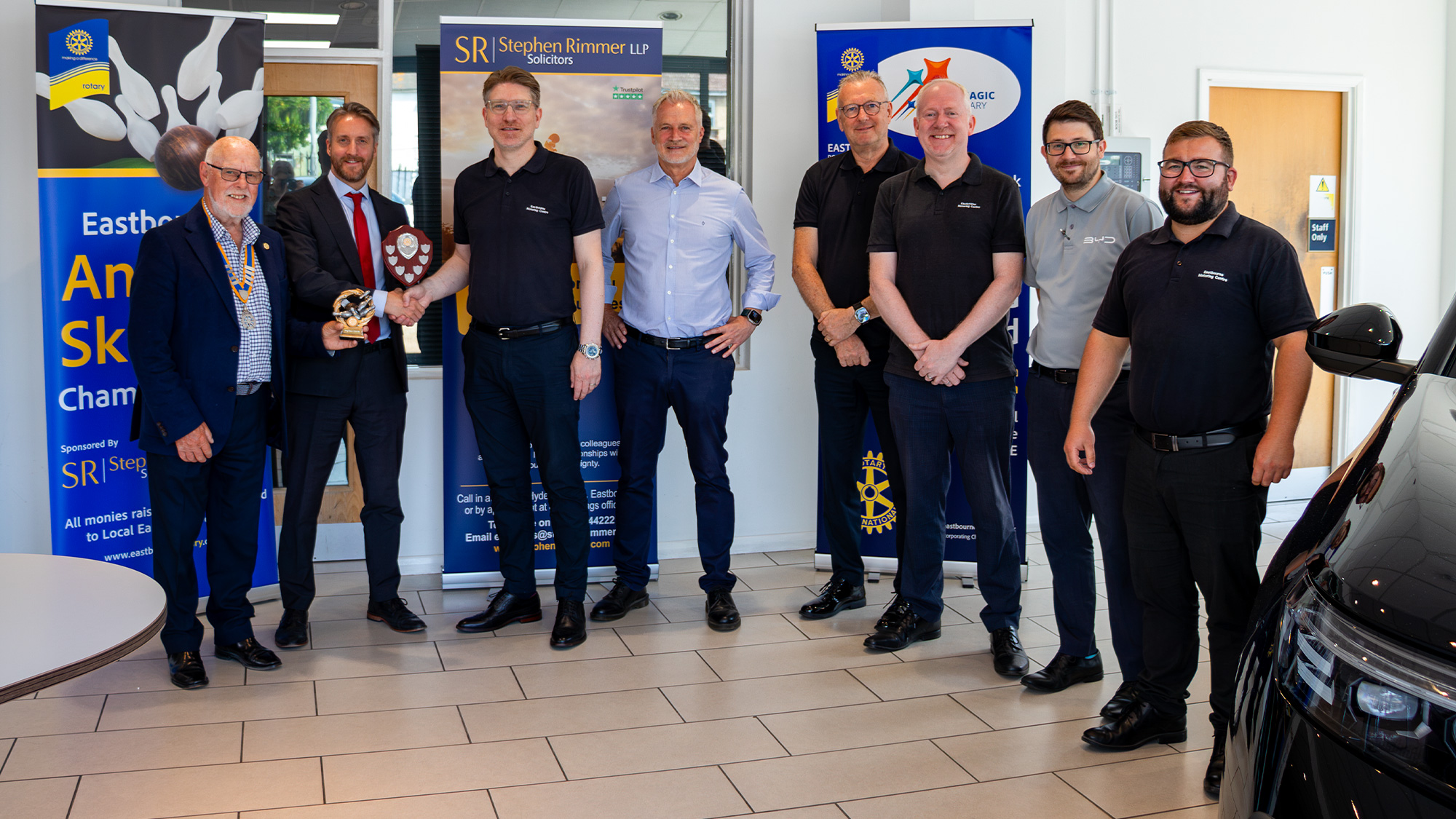 Eastbourne Motoring Centre skittles team receiving the Eastbourne Skittles Championship shield and highest individual score trophy at Eastbourne Motoring Centre on 23 July after their fourth consecutive championship victory.